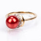 Anillo de Plata Bañada en Oro con Perla roja de río y Topacio Blanco